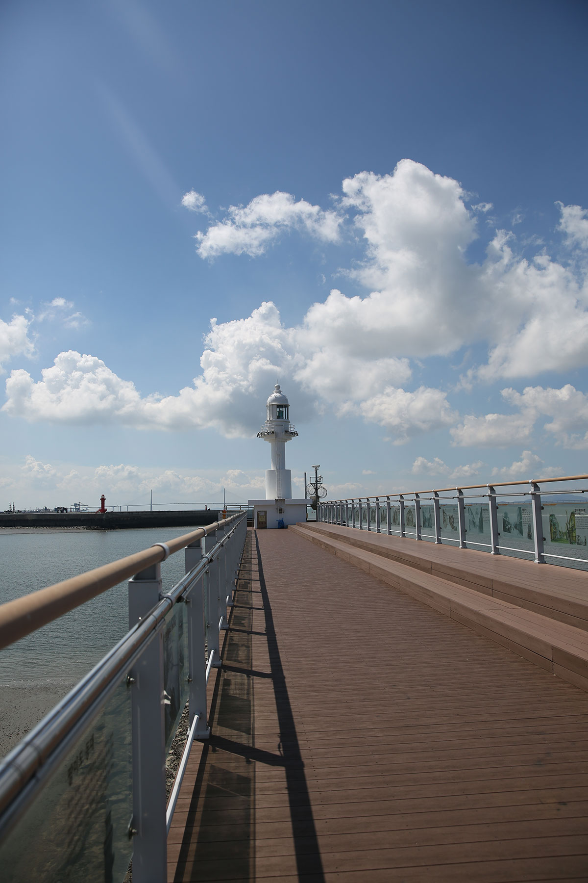 An outdoor boardwalk towards the lighthouse